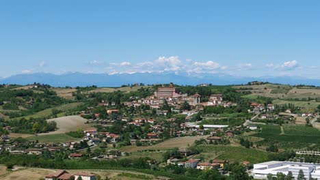 picturesque town of piedmont in italy with alps mountains in background