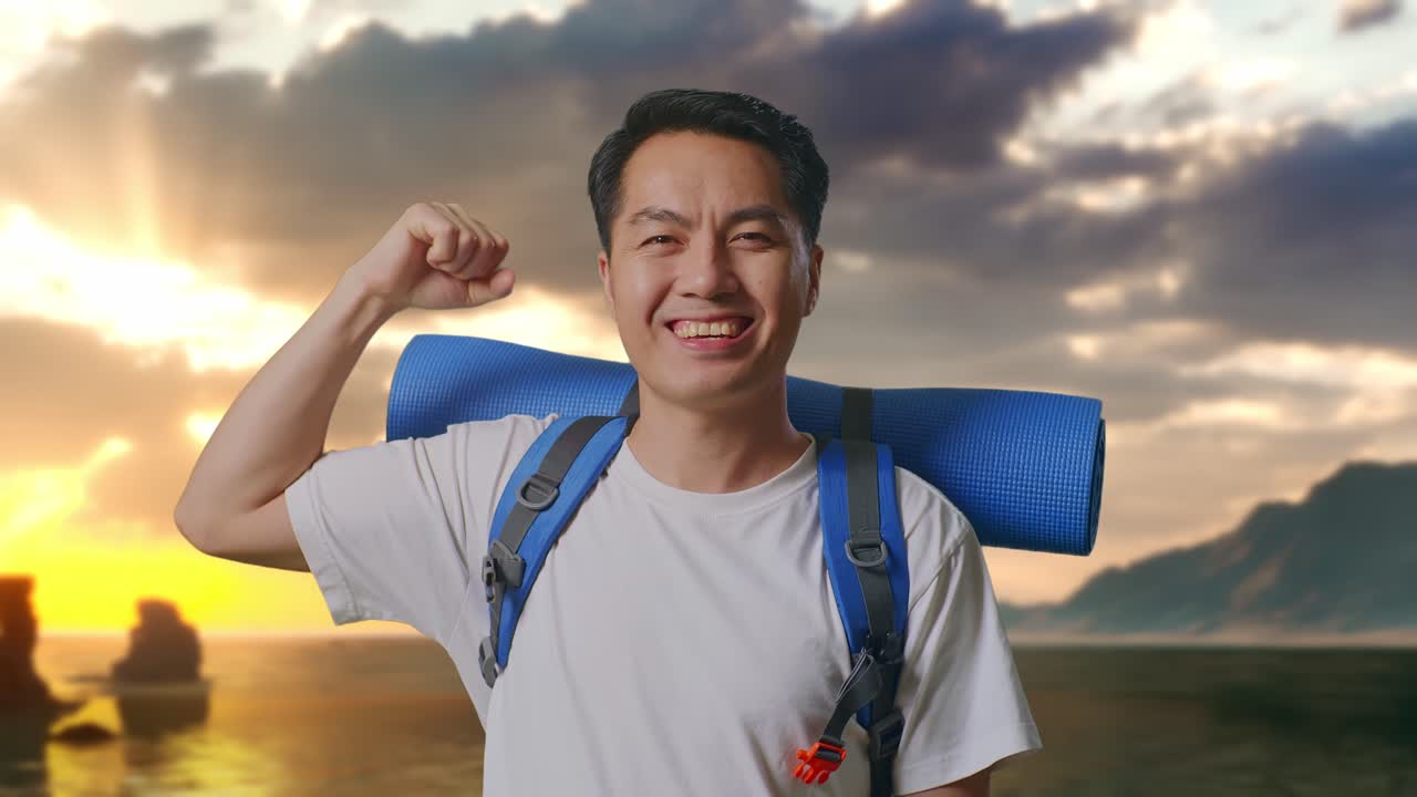 Close Up Pendaki Pria Asia Dengan Ransel Mendaki Gunung Tersenyum Dan Memamerkan Otot Bisepnya di Pantai