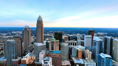 beautiful uptown of charlotte, north carolina, usa. drone going up along the modern skyscrapers at backdrop of blue sky