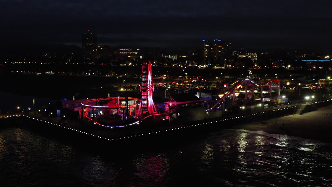 Santa Monica Pier at Night with Illuminated Ferris Wheel and Roller Coaster