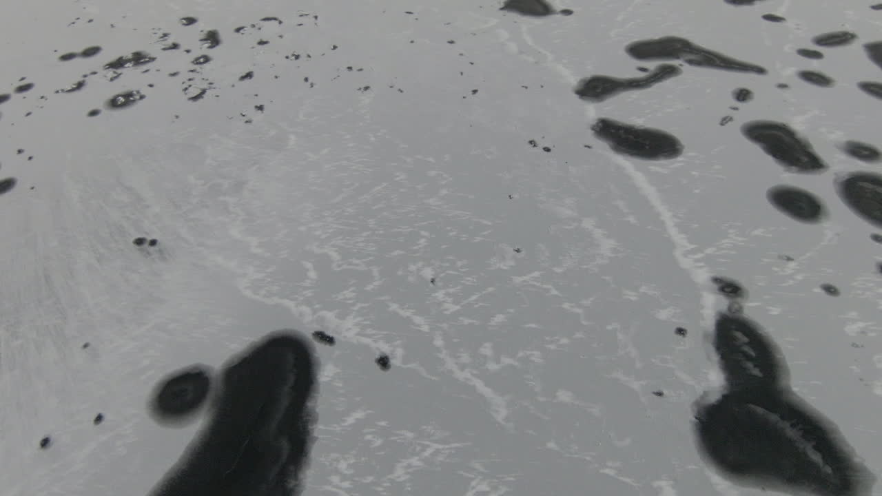 Tilt down, icy frozen lake from above, dolly forward
