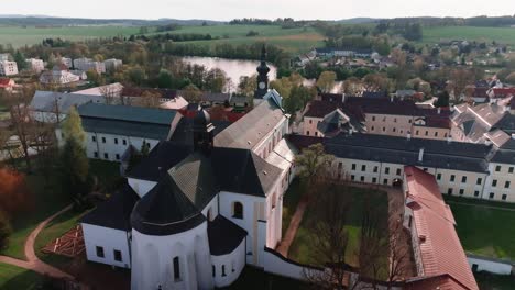 Drone-view-of-the-monastery-and-church-in-Zdar-nad-Sazavou-at-sunset,-Czech-Republic