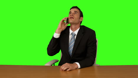 Businessman-talking-on-the-phone-at-his-desk