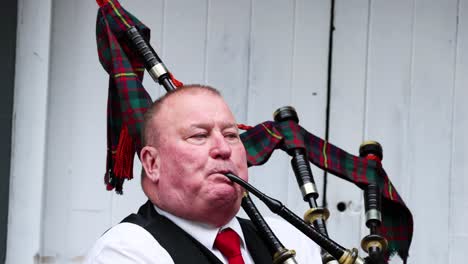 man playing bagpipes at festival in edinburgh