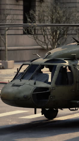 a close-up of a military helicopter parked on a city street