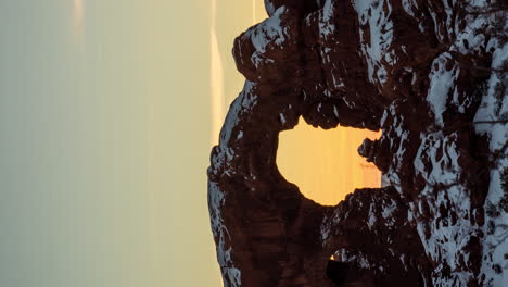 vertical 4k timelapse, sunrise above natural arch, arches national park utah usa at winter season