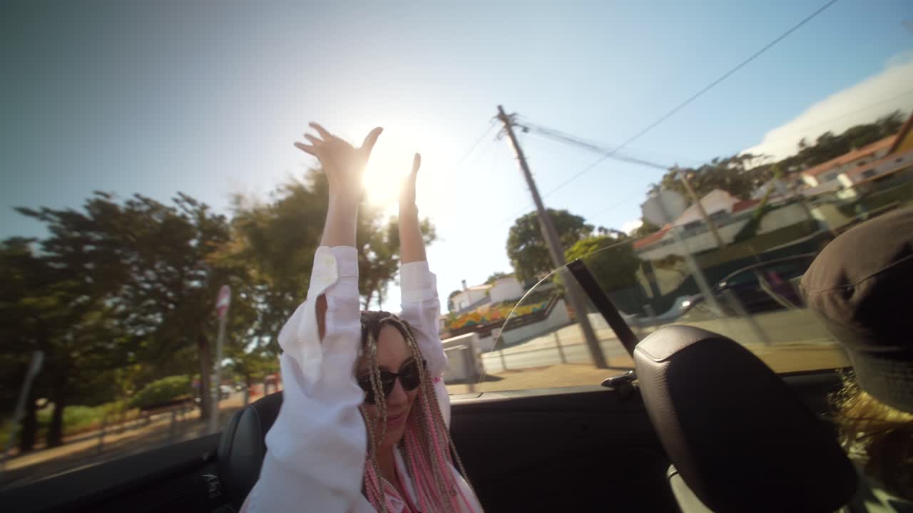 Woman with Braids Enjoying a Sunny Convertible Road Trip