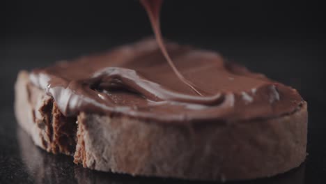 spreading chocolate cream on a slice of rye bread