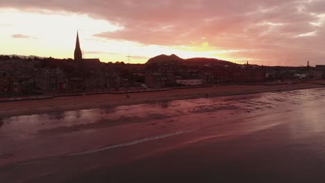 Beautiful-Portobello-Beach-in-Edinburgh-during-dramatic-sunset--Aerial-static-shot