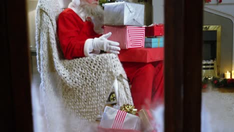 Santa-claus-holding-christmas-gift