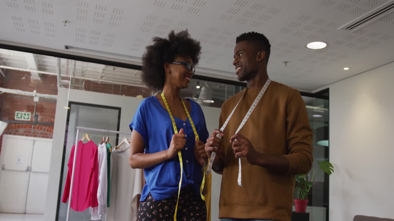 retrato de diseñadores de moda afroamericanos masculinos y femeninos mirando a la cámara y sonriendo