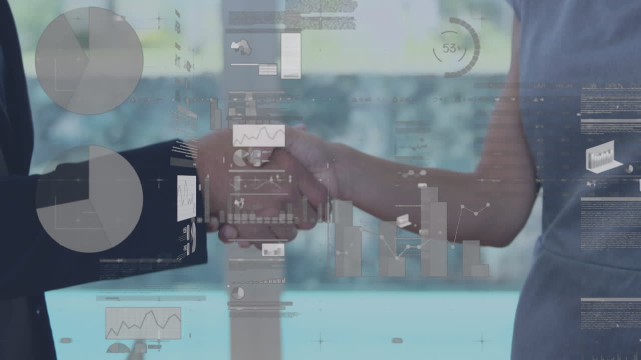 Screens with data processing against mid section of businessman and businesswoman shaking hands