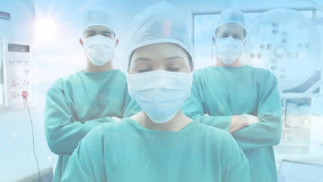 composición digital de puntos de luz contra el retrato del equipo de cirujanos en el hospital