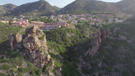 panoramic aerial view over the city of nebida on the island of sardinia and where two large rock formations can be seen