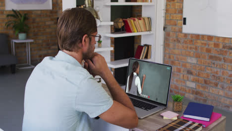 Caucasian-male-student-using-laptop-on-video-call-with-female-teacher