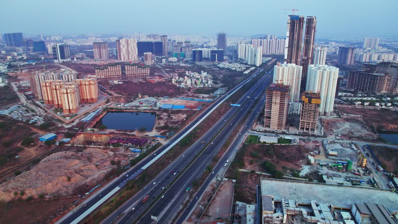 aerial view of financial district with under construction buildings and sky at nanakramguda, Kokapet, hyderabad, telangana, india. day time, semi orbit, drone shot, 4k.