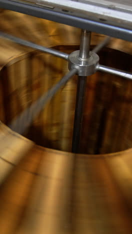honey extracting machine working. honey frames are rotated in the apparatus to get fresh organic product. close up. vertical video