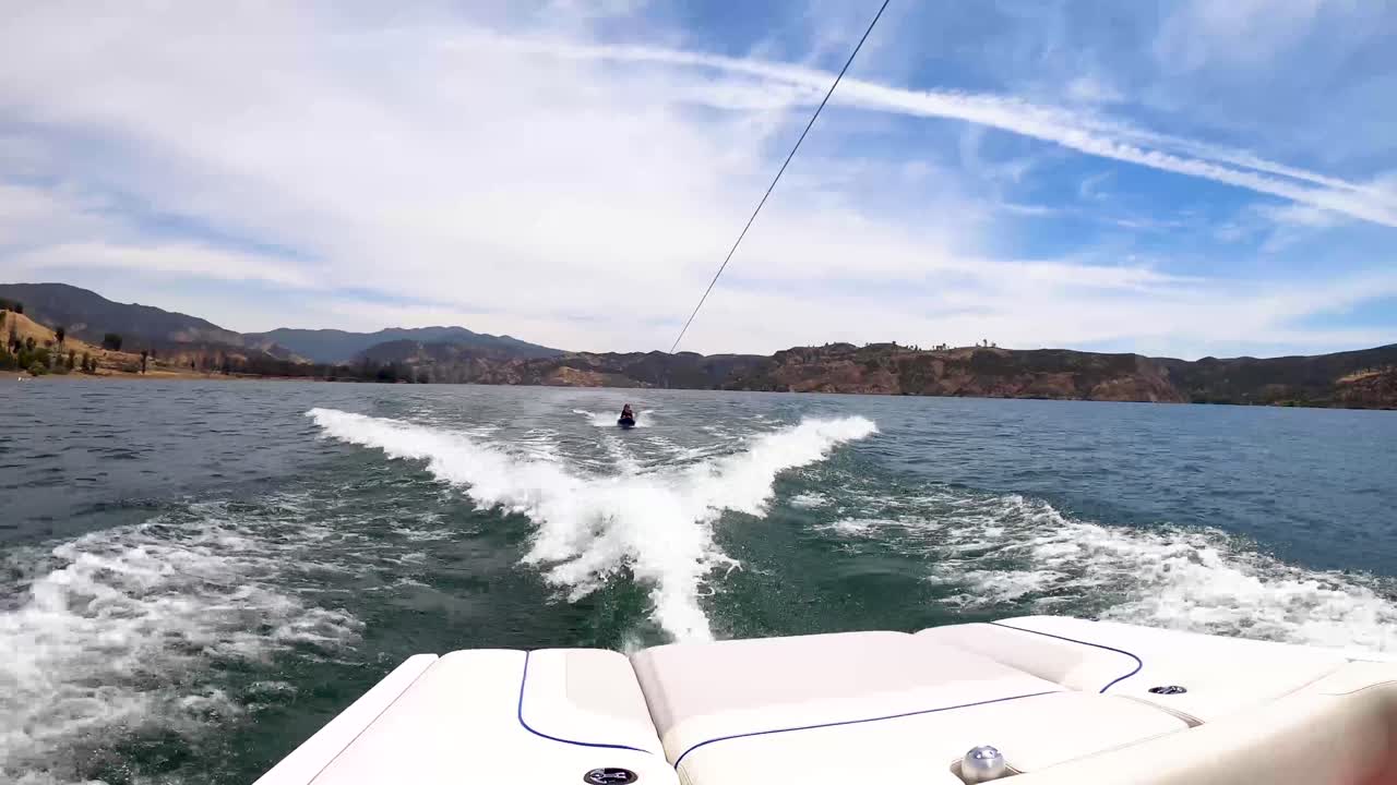 A kid knee boarding at Castaic Lake in California.