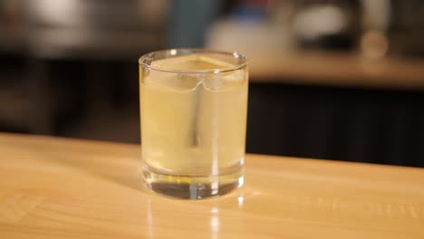 yellow cocktail on a wooden bar