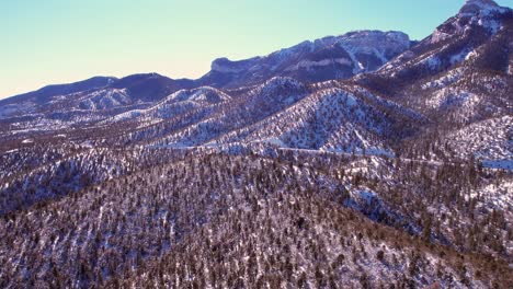dramatic aerial view flying across snow covered mountain range extreme peaks