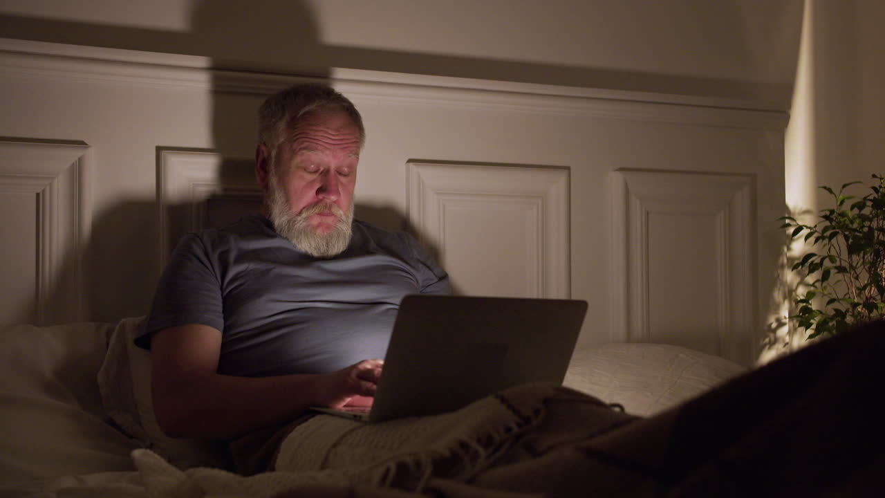 Old tired man on bed