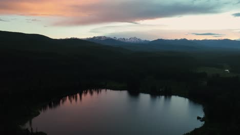 aerial view over the tranquil waters of whitefish lake at dusk in montana, united states - drone shot