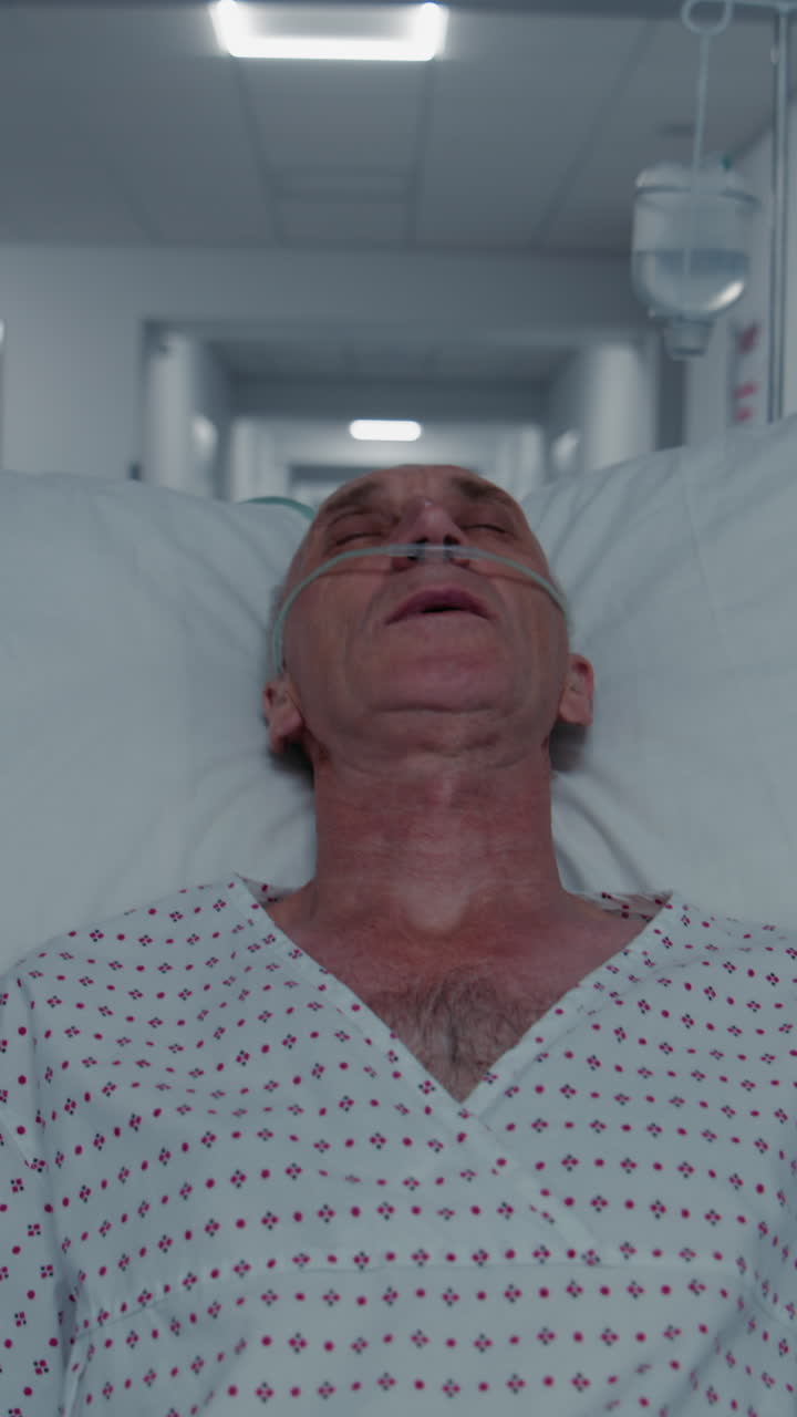Old patient sleeps on gurney with breathing tube a 4k 2025 08 05 02 28 22 utc.mov | african american, breathing tube, care, caucasian
