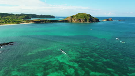 paradise exotic island of kuta lombok with small boats and mountains, aerial view