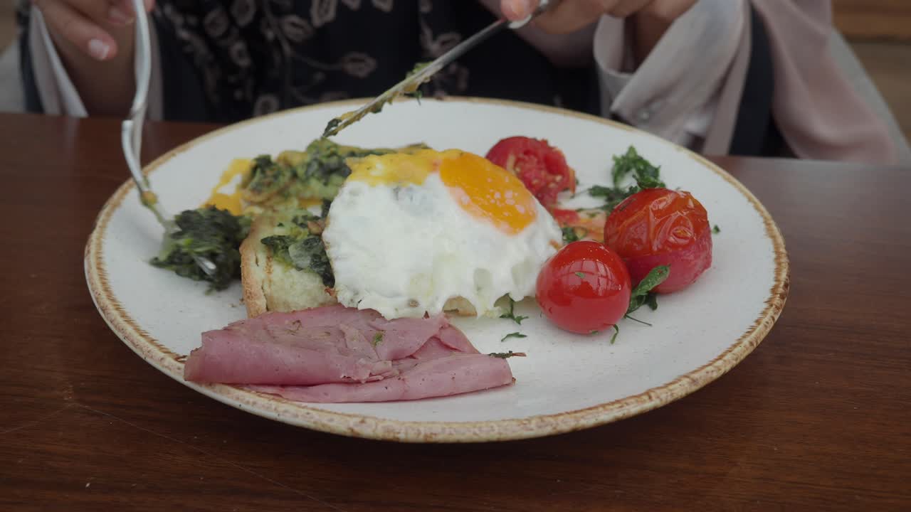 Breakfast plate with egg, ham, and tomatoes