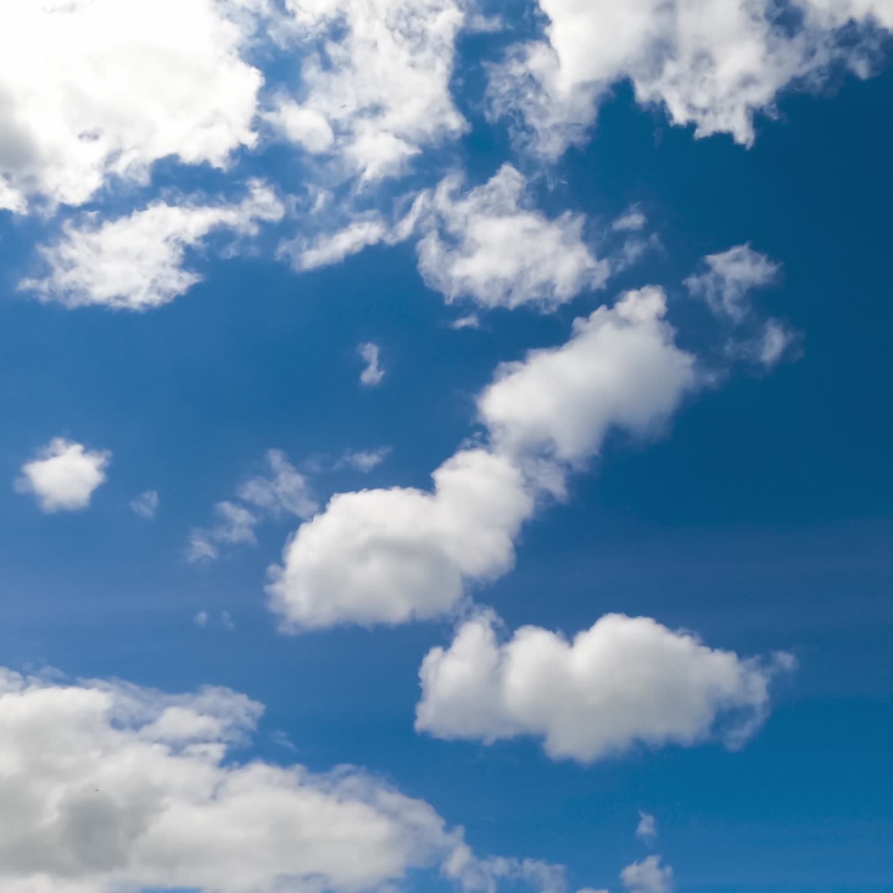 Soft white clouds transforming in the sky. Beautiful fluffy clouds flying quickly timelapse
