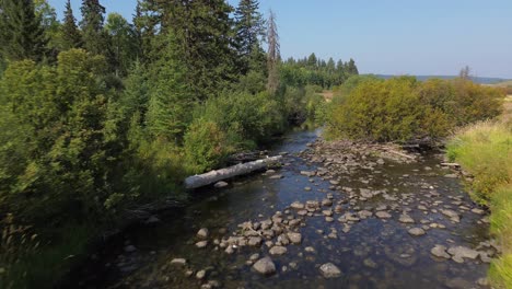 aerial drone tracks stream along cariboo highway near 127 mile house, bc, canada