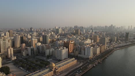 4k: aerial view of sharjah's old town with city skyline, residential towers in the united arab emirates