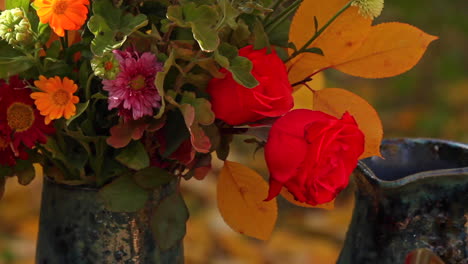 Pan-right-view-of-Thanksgiving-flowers-in-vase-on-table-outside-in-garden