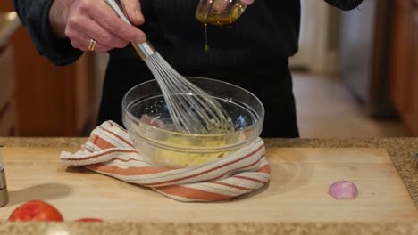 mixing oil to ingredients to make salad dressing