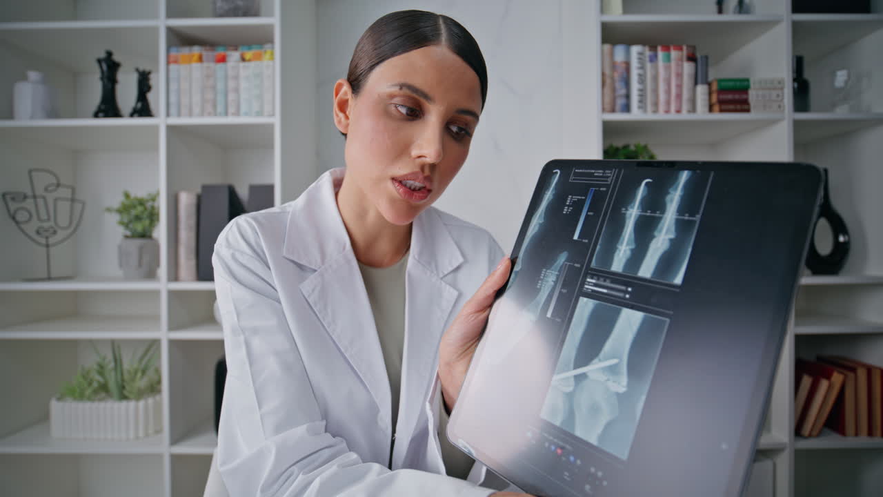 Clinic physician discussing x-ray by video call in healthcare facility closeup
