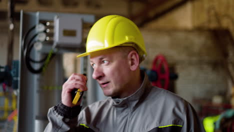 man with yellow hardhat at the factory