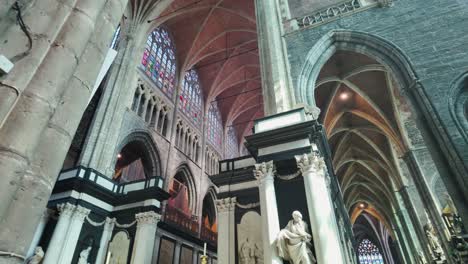 gothic interior of saint bavo's cathedral with stained glass and sculptures in ghent belgium