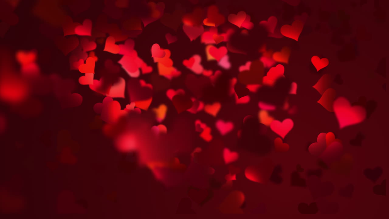 Blurred romantic dark background with flying red hearts in the light of night lanterns. for valentines festival of love.