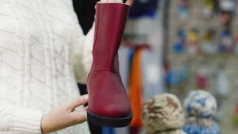 hands of the buyer holds warm winter shoes