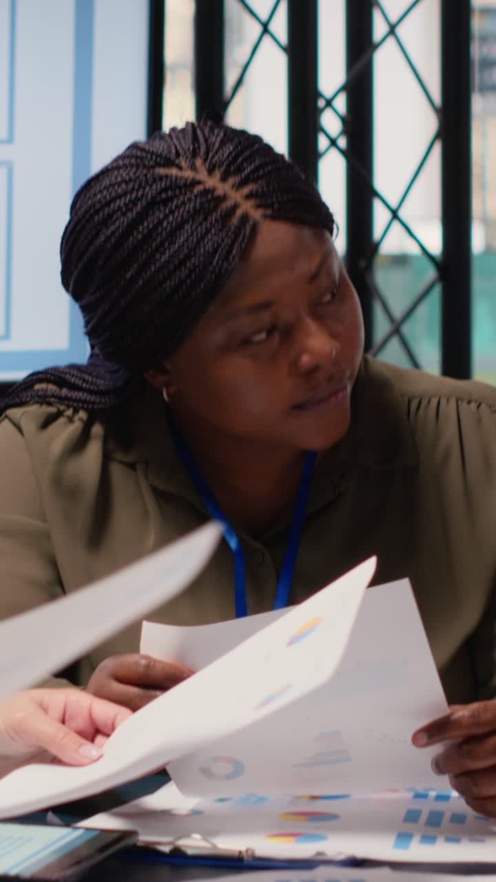 Vertical Video Group of businesswomen engaging in collaboration during briefing session