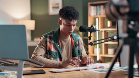 man at desk working with computer and microphone