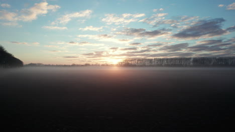 Drone-accelerates-through-the-morning-haze-on-the-dutch-agricultural-field