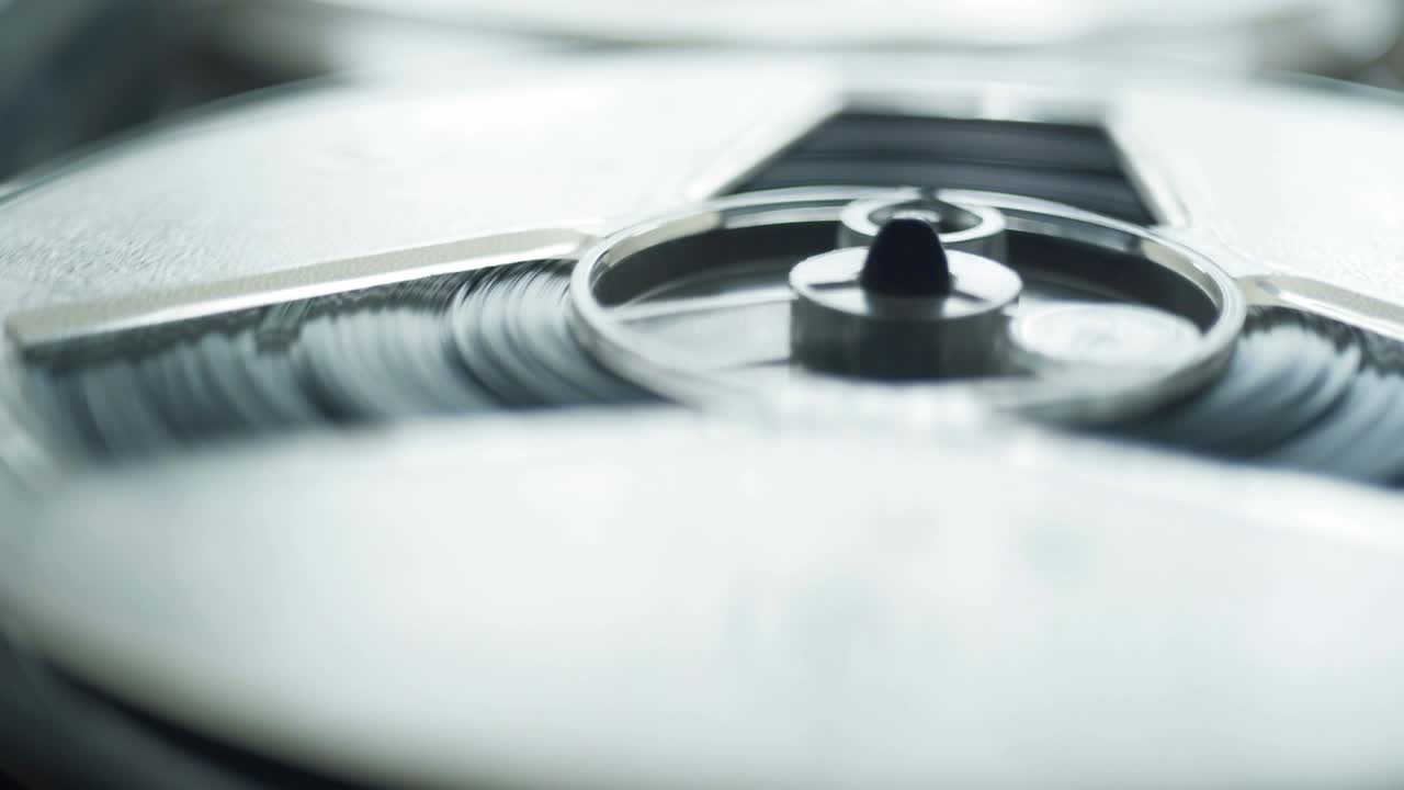 Reel film tape is rotating at a vintage professional player. Oldschool equipment
