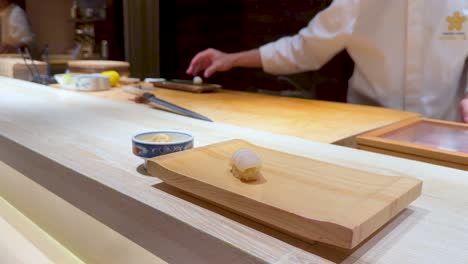 chef skillfully crafts sushi in a restaurant