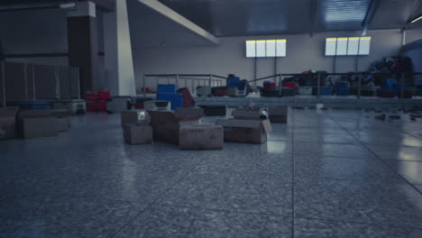 empty airport terminal with luggage and boxes