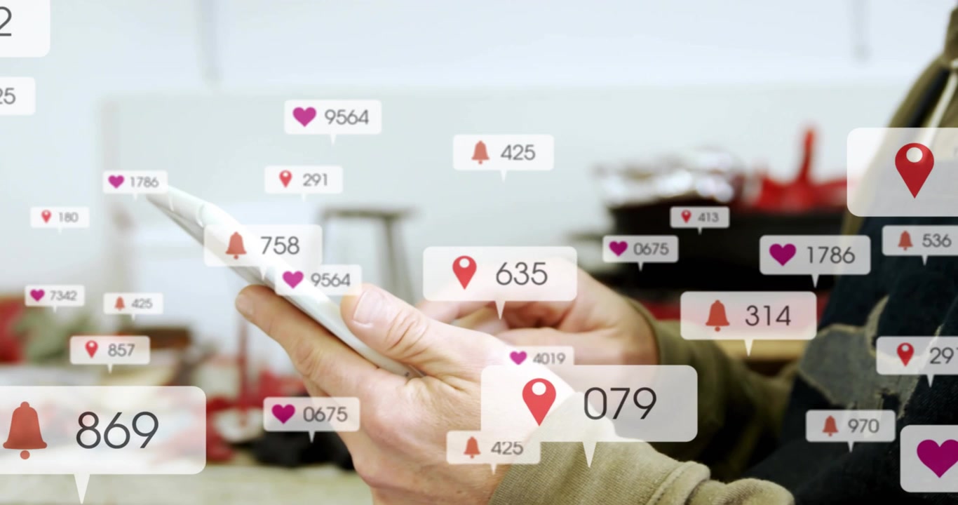 artisan tapping phone screen and displaying heart counts bell pins tracking tech notifications