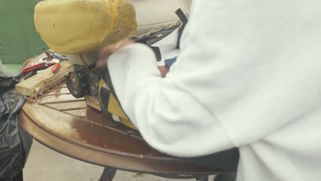 skilled upholsterer fitting leatherette to a car seat