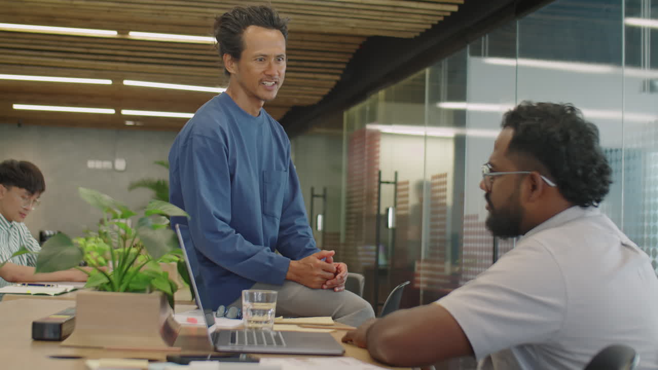 Two Men Chatting about Business in Coworking Room