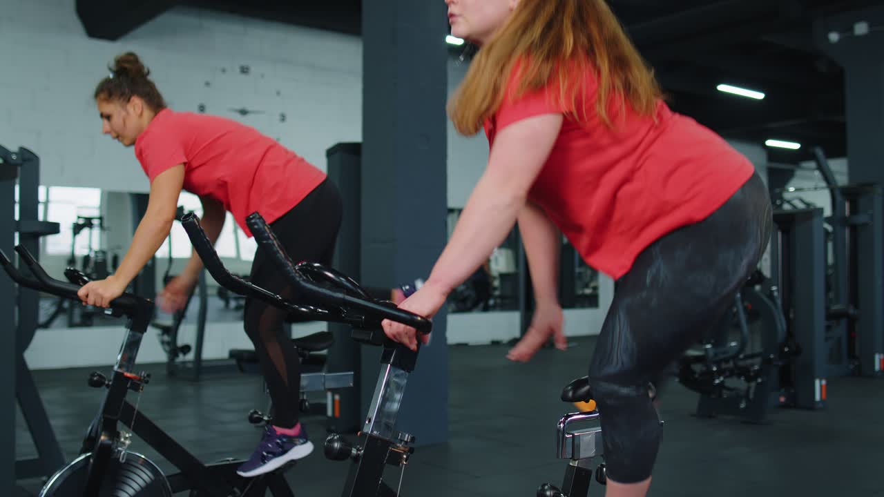 Group of girls performs aerobic training workout cardio routine on bike simulators cycle training
