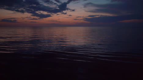 beautiful sunset sky with calm dark sea